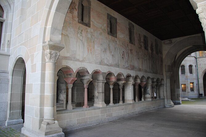 Zurich 360° City Walk Tour Including Hidden Spots - St. Peter’s Church and Münsterhof: Clocks, Roman Layers, and Legends